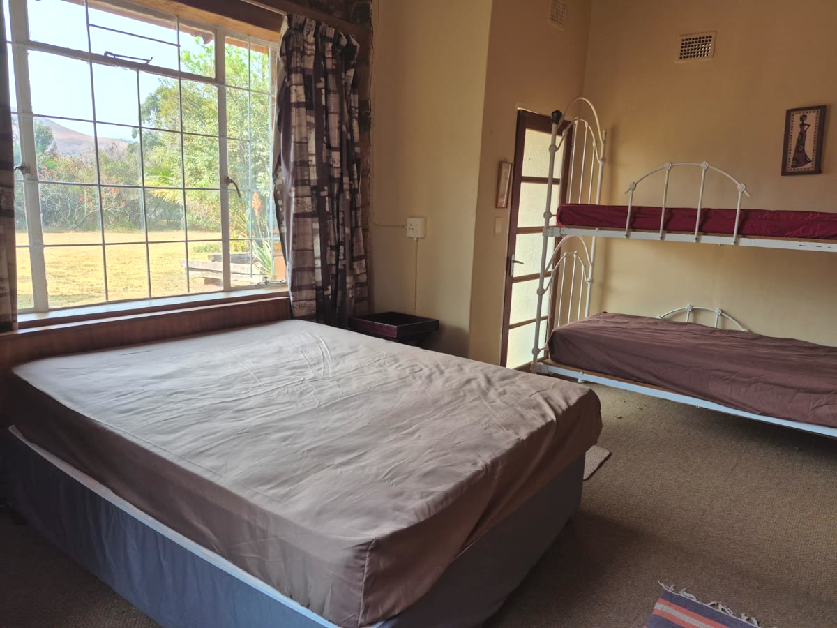 Bedroom with a double bed and a big window onto the garden