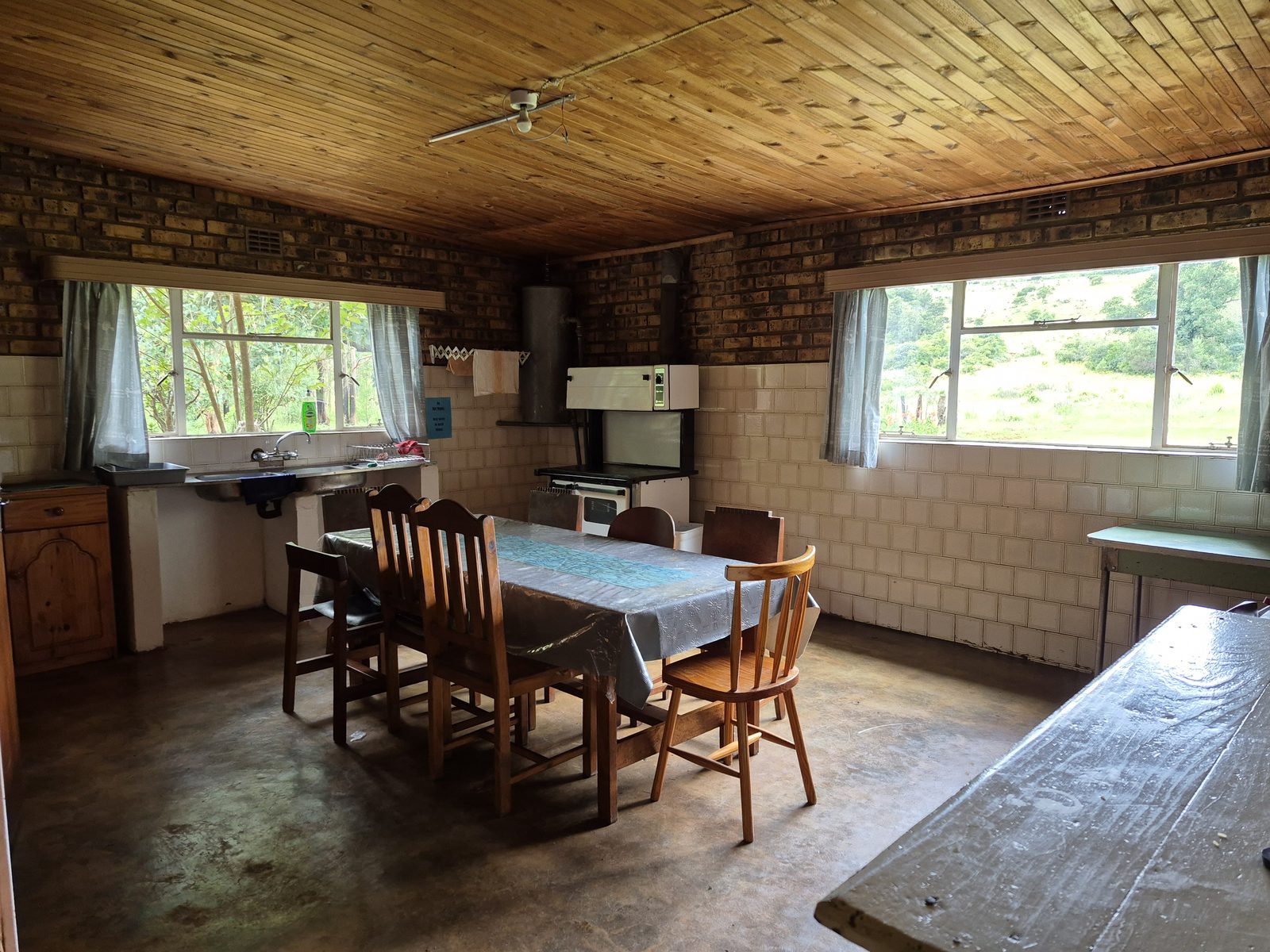 Farmhouse kitchen with brick walls and a long table